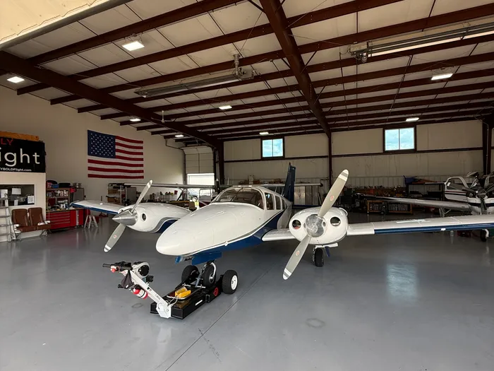 Twin engine aircraft being detailed inside a hangar