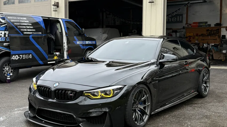 BMW M4 with tinted windows at the Platinum Pro Clean shop